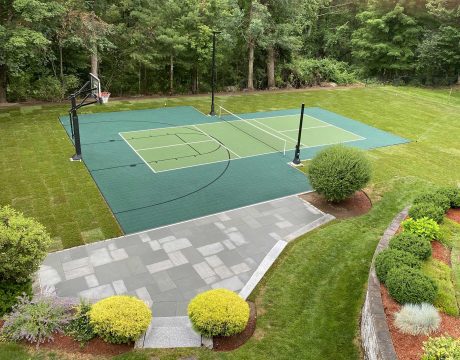 Image of backyard basketball court and pickleball court with nice landscape