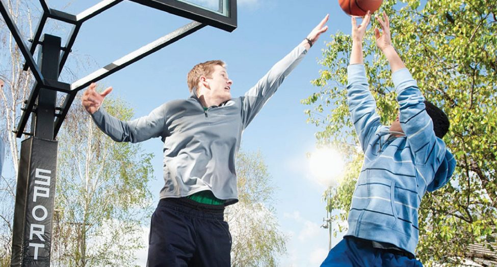 Two friends playing basketball