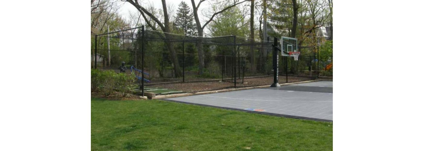 Batting cage next to basketball court